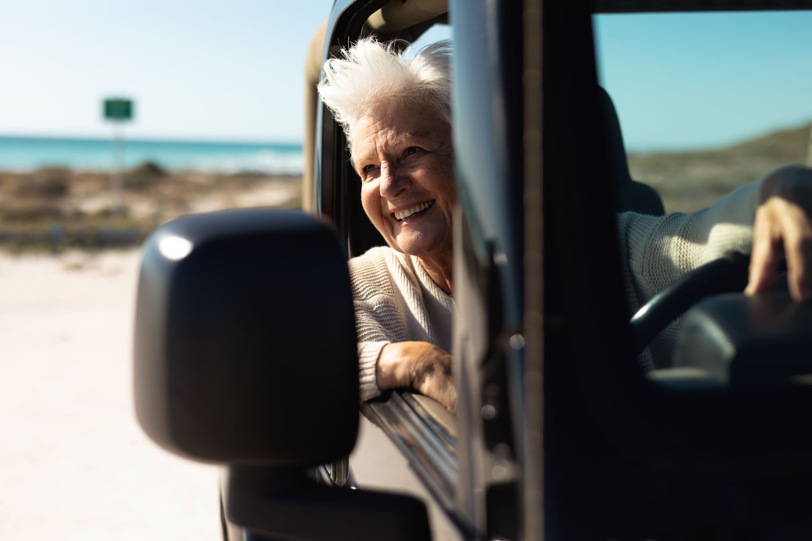 older-woman-in-car-at-the-beach