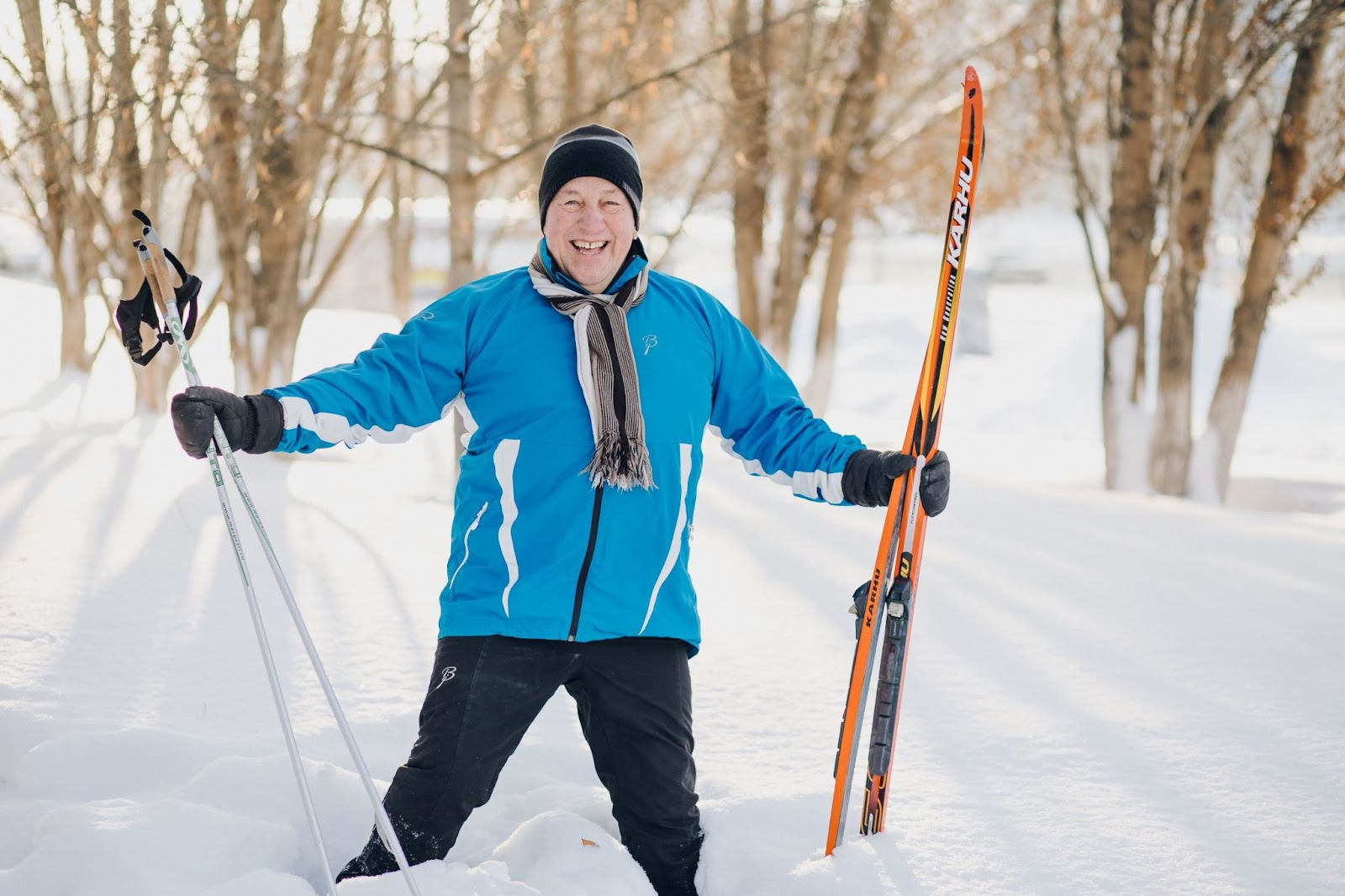 older-man-with-cross-country-skis-in-forest