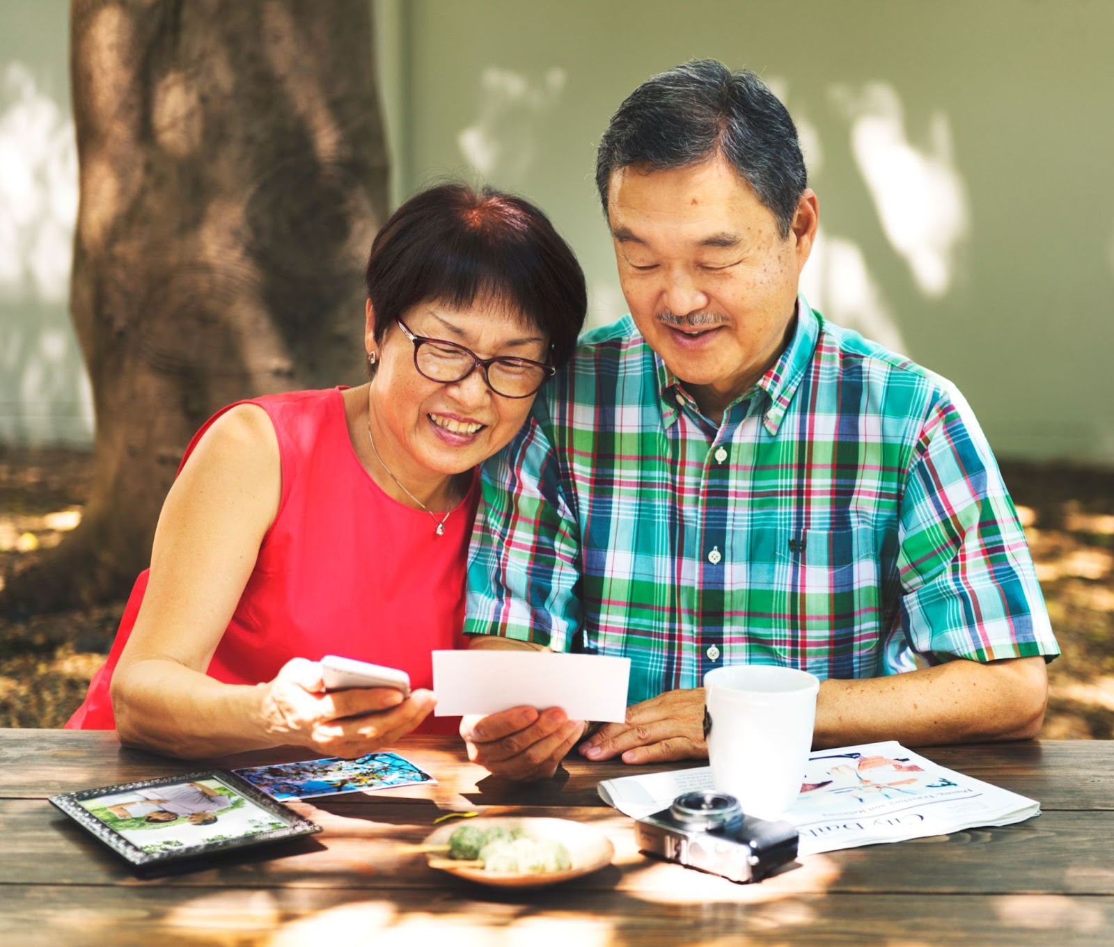 senior-asian-woman-and-man-looking-at-photos