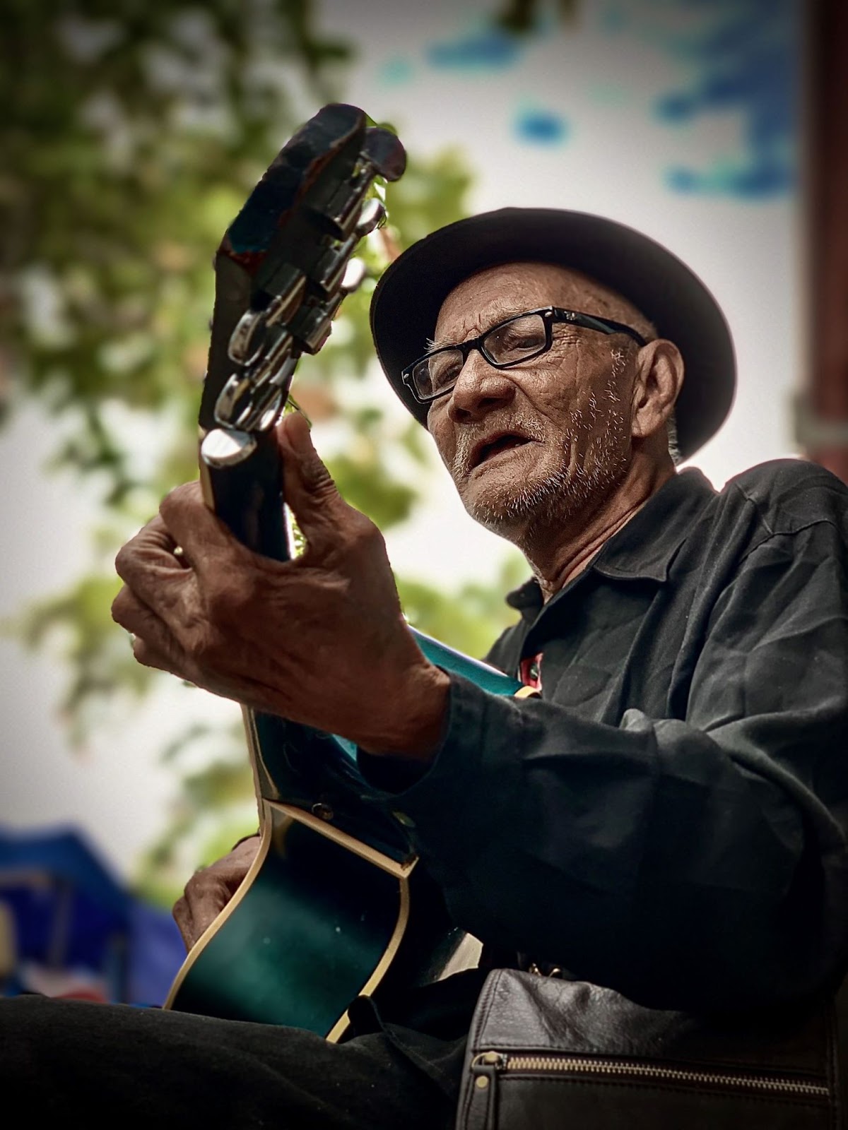 older-man-strumming-his-guitar-and-singing