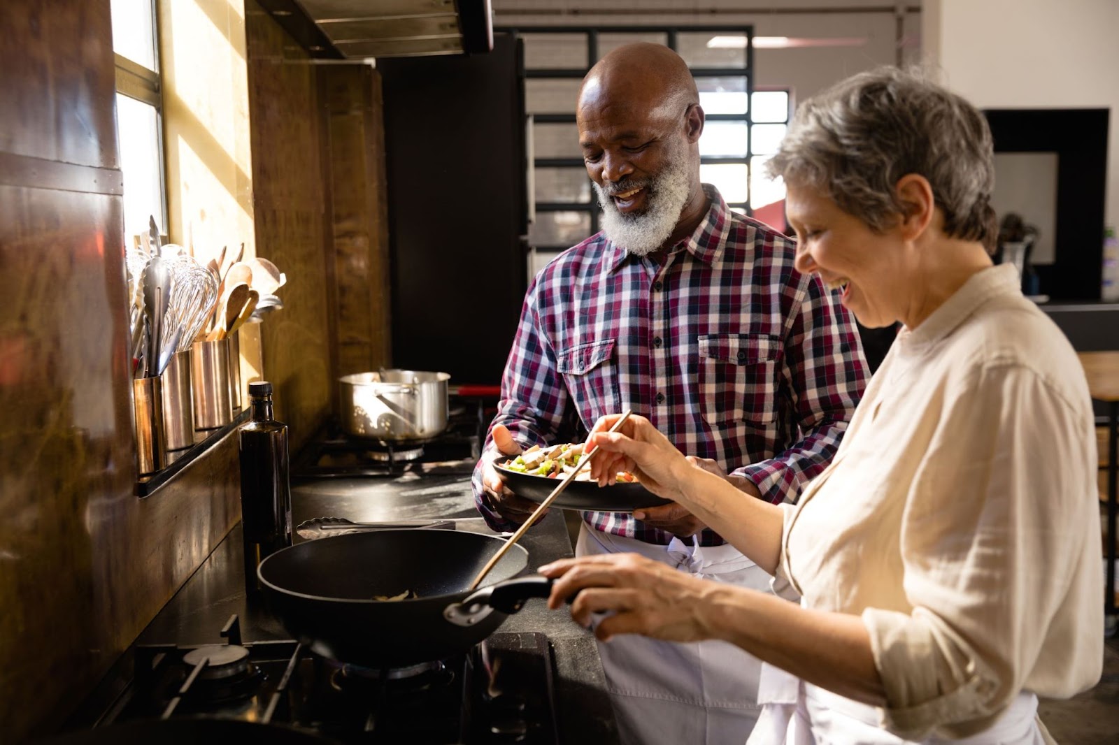 older-caucasian-woman-and-older-african-american-man-cooking