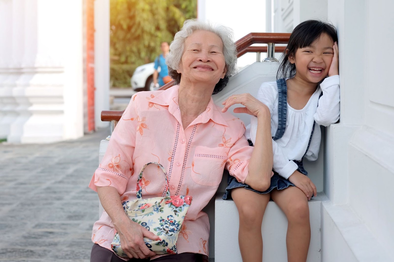 senior-woman-and-girl-laughing-outdoors