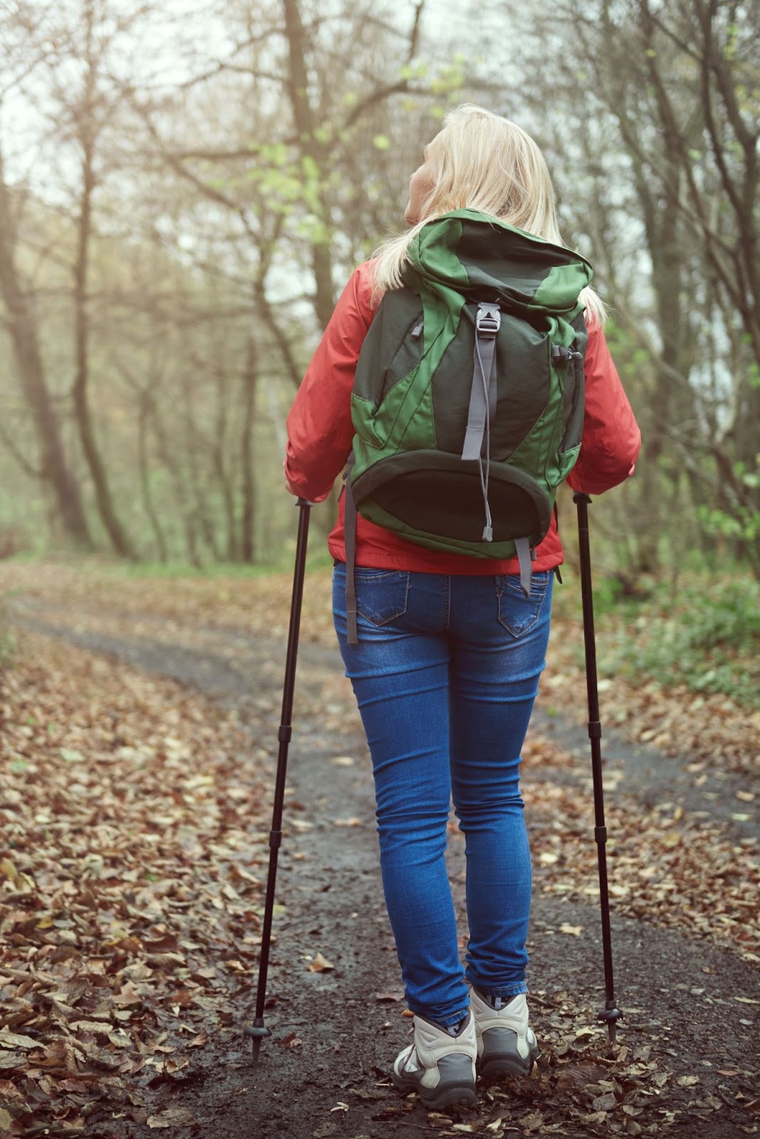 woman-in-forest-with-trekking-poles