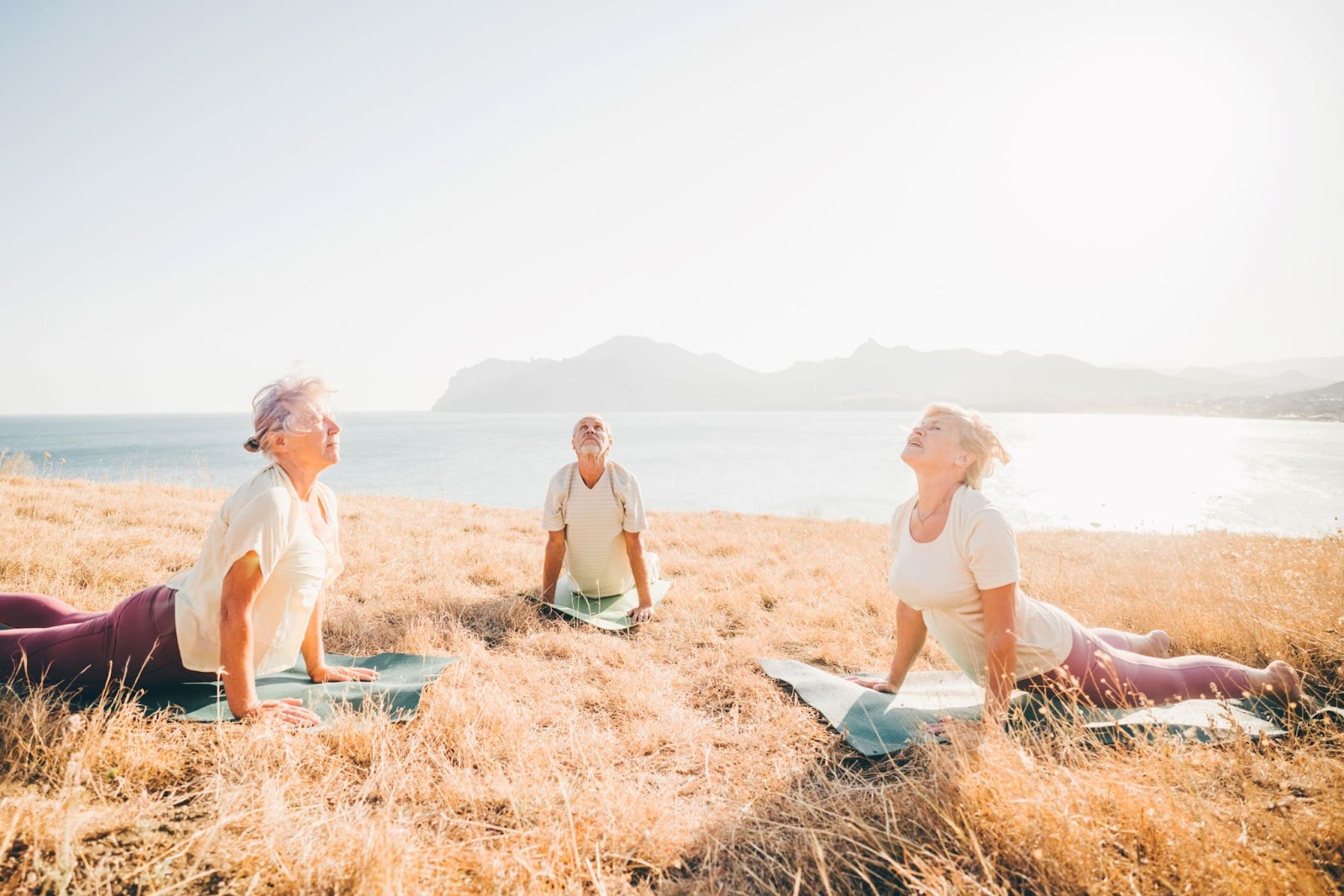 group-of-older-people-doing-yoga-outdoors