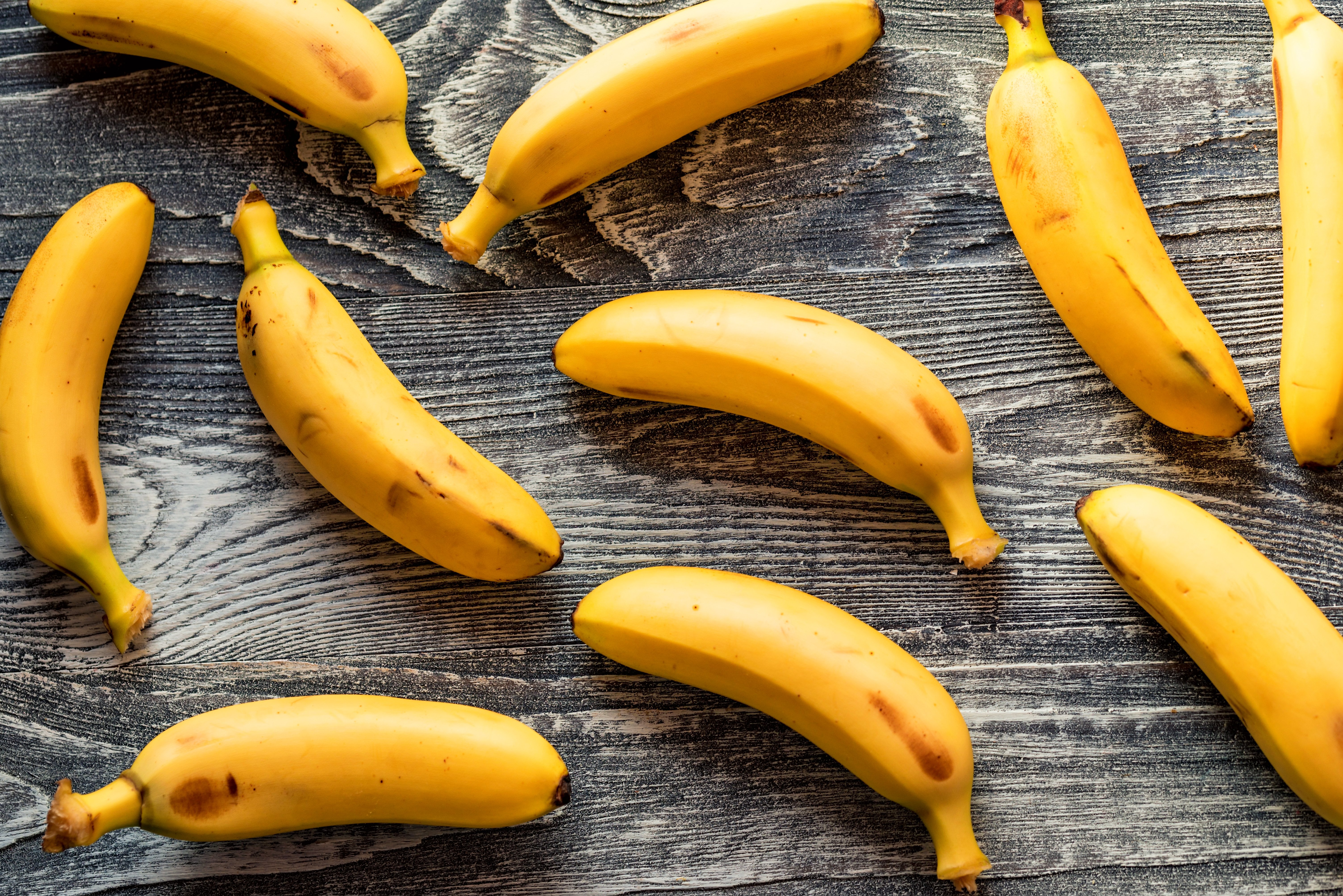 bunch-of-bananas-on-wooden-background-F94XJY6