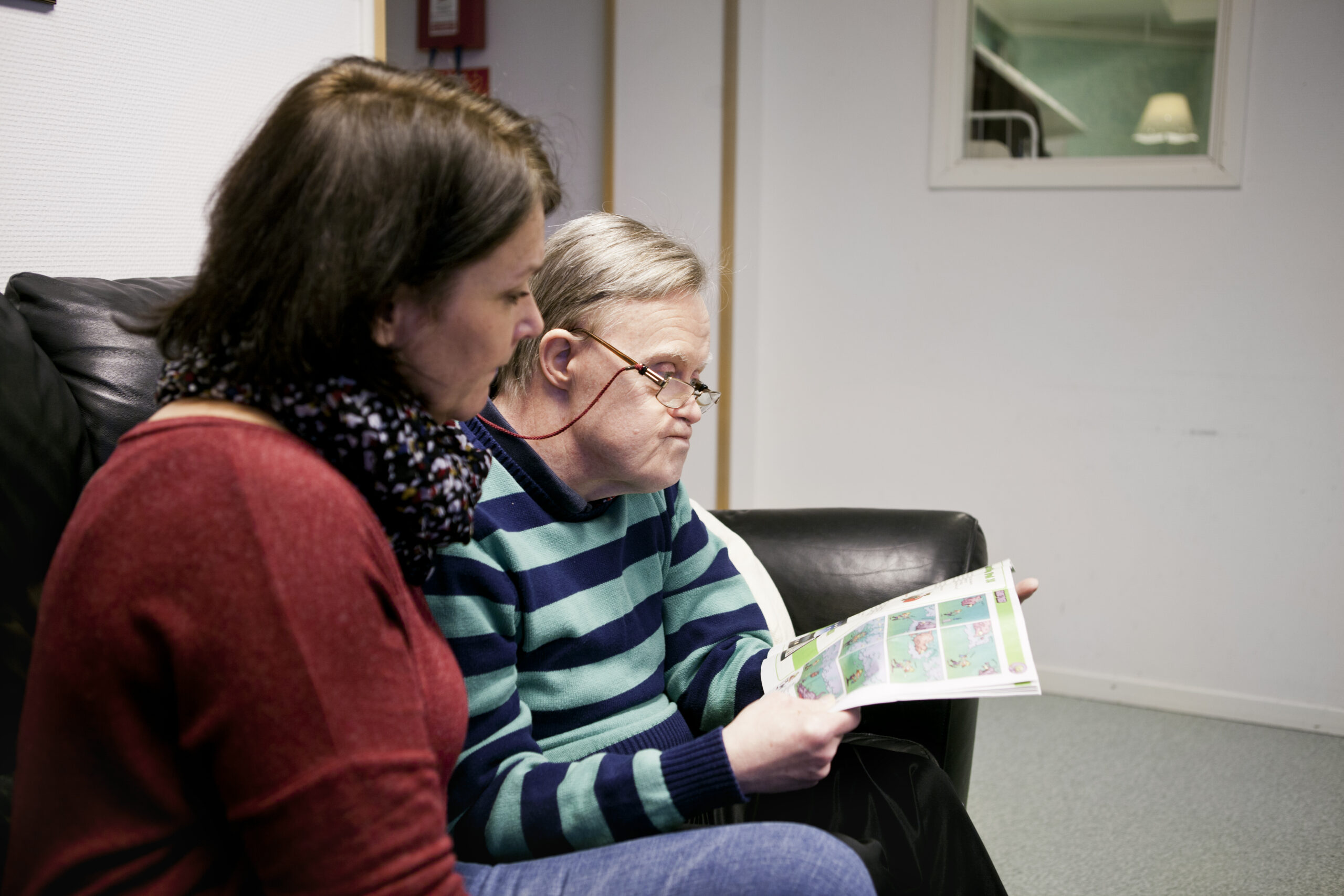 caregiver-sitting-with-special-needs-senior-man