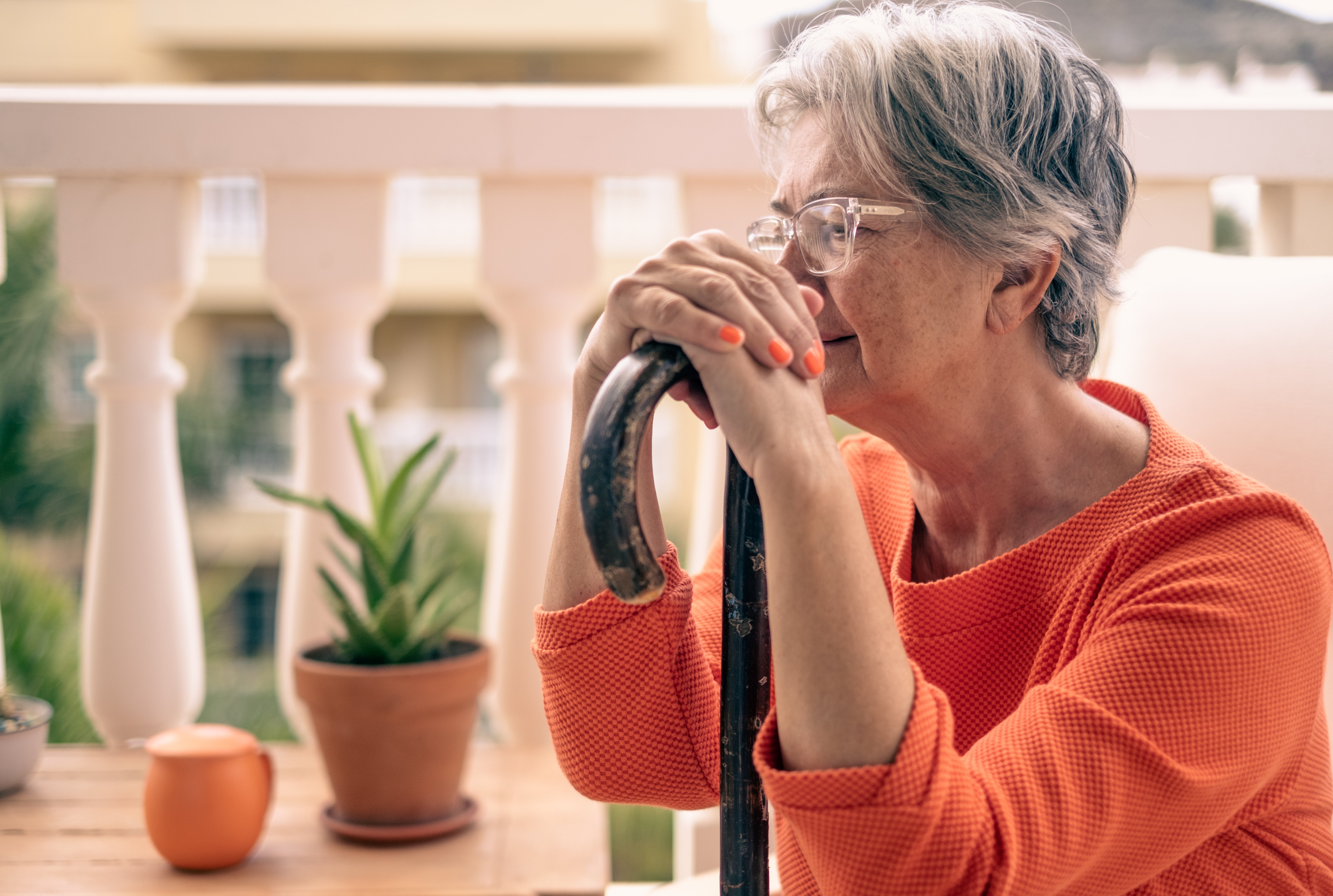 close-up-of-senior-woman-with-cane-looking-depressed