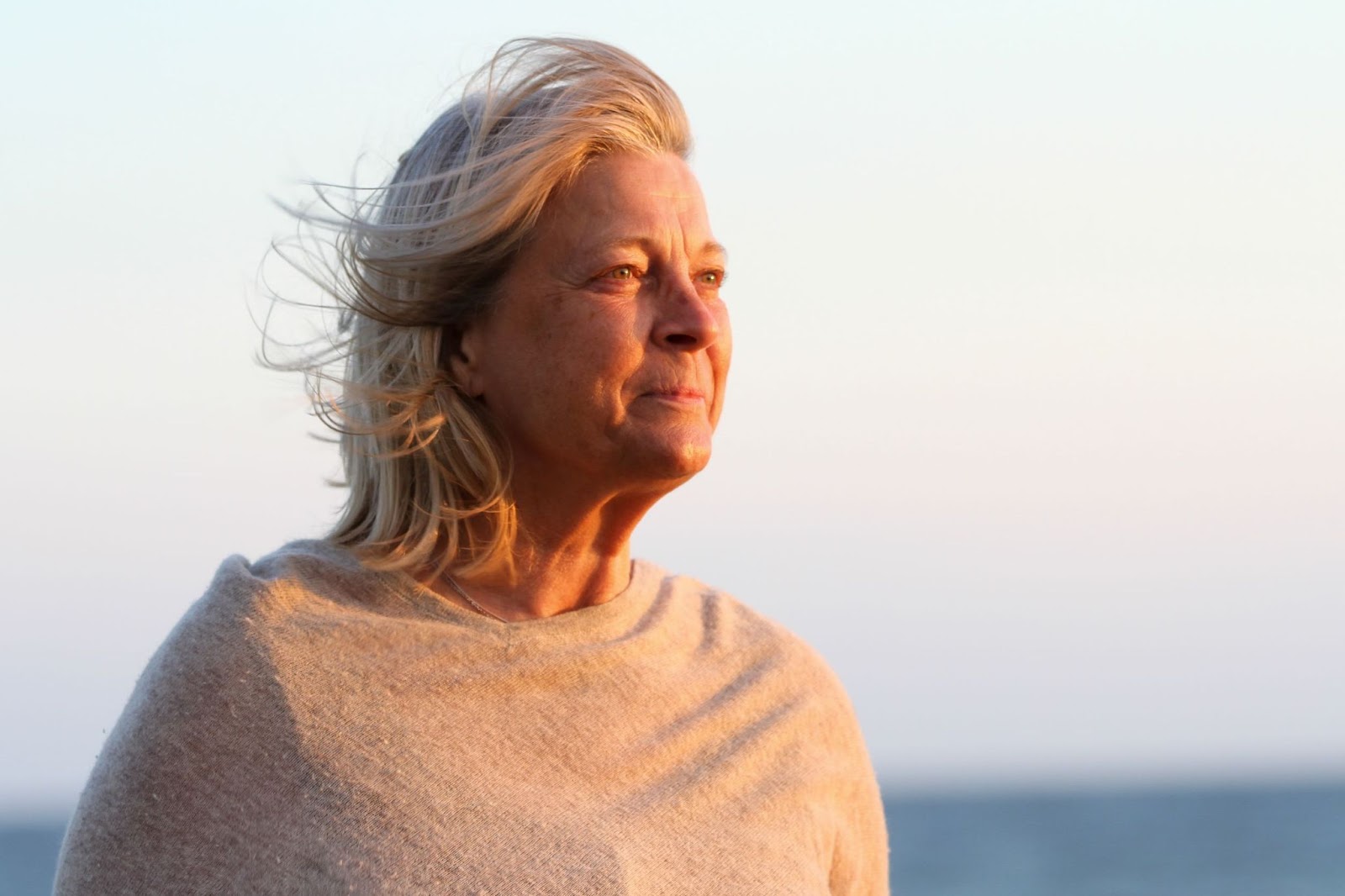 Older-woman-outdoors-calmly-viewing-sunrise