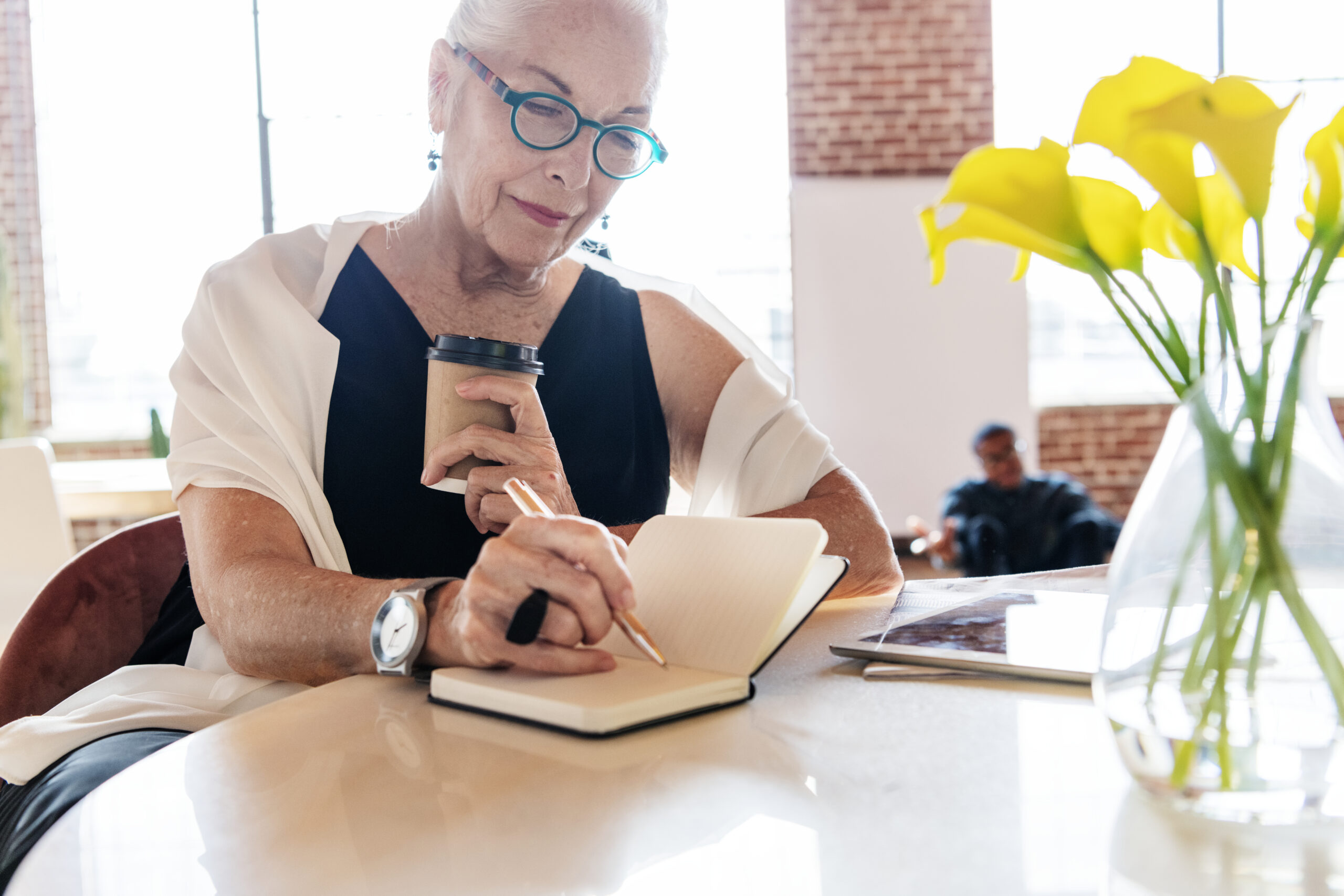 mature-stylish-woman-writing-in-a-journal