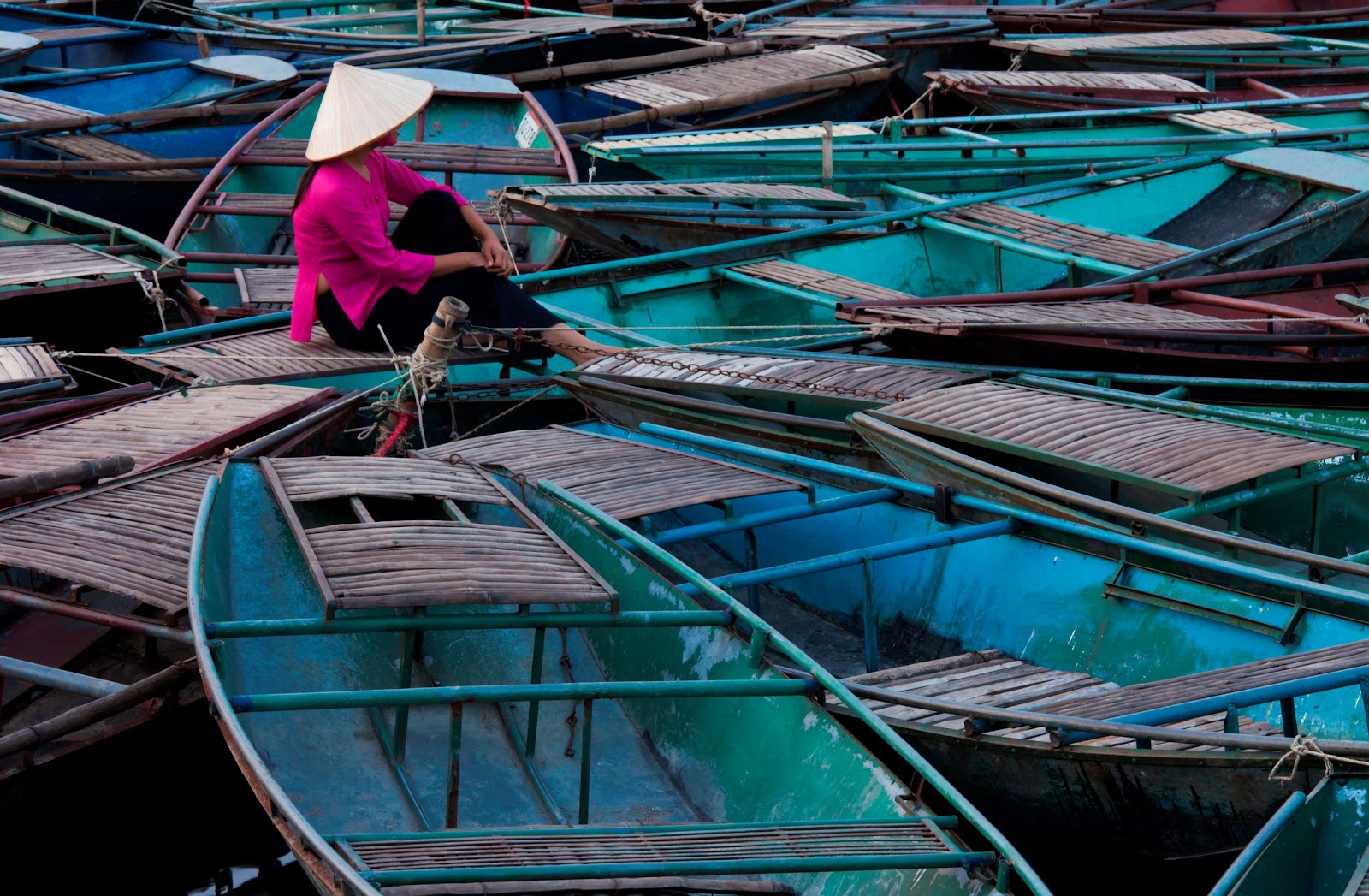 woman-sitting-among-raft-of-boats