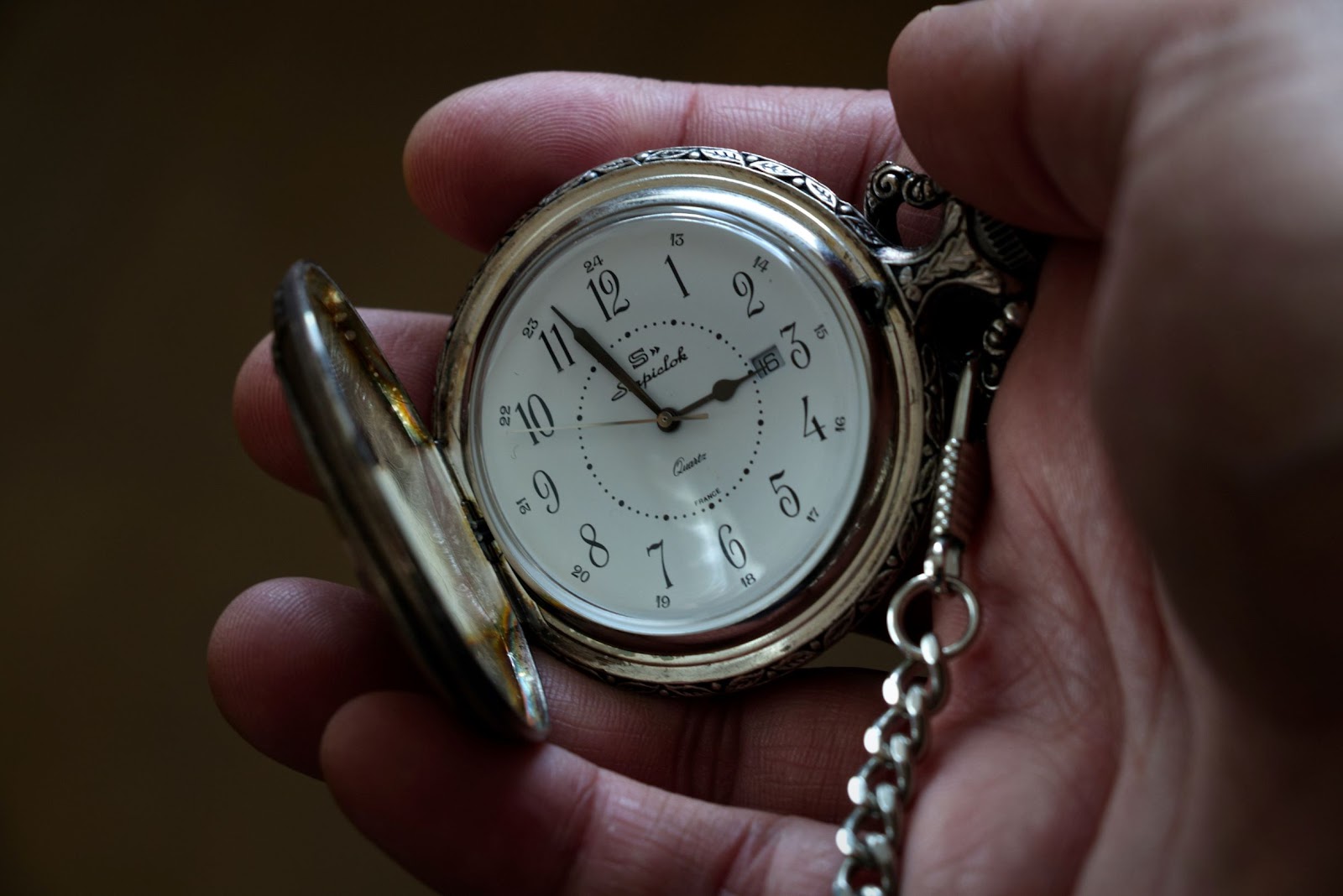 Hand holding old-fashioned wristwatch