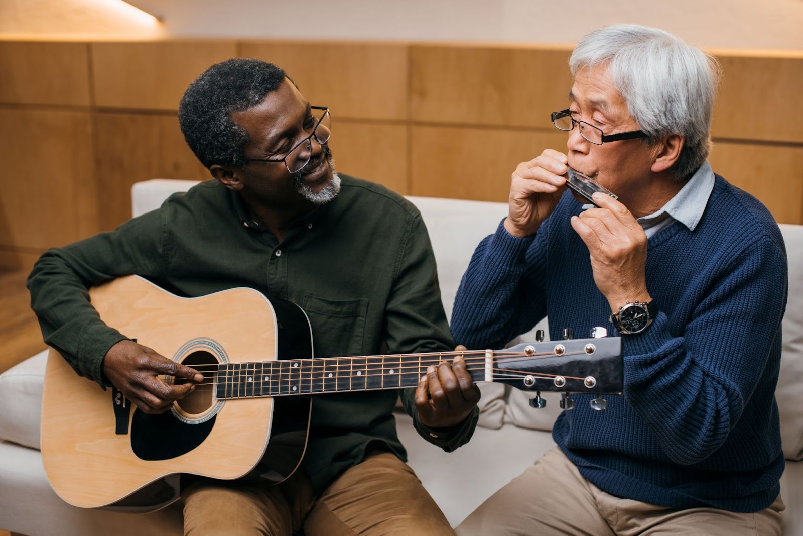 senior-friends-playing-music-with-acoustic-guitar-and-harmonica