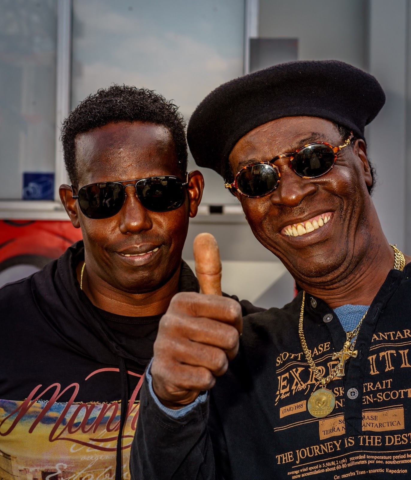 older-man-and-younger-man-in-sunglasses-giving-thumbs-up