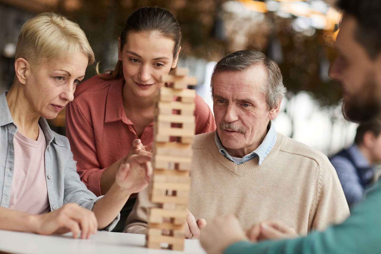 senior-man-and-family-playing-a-game-of-Jenga