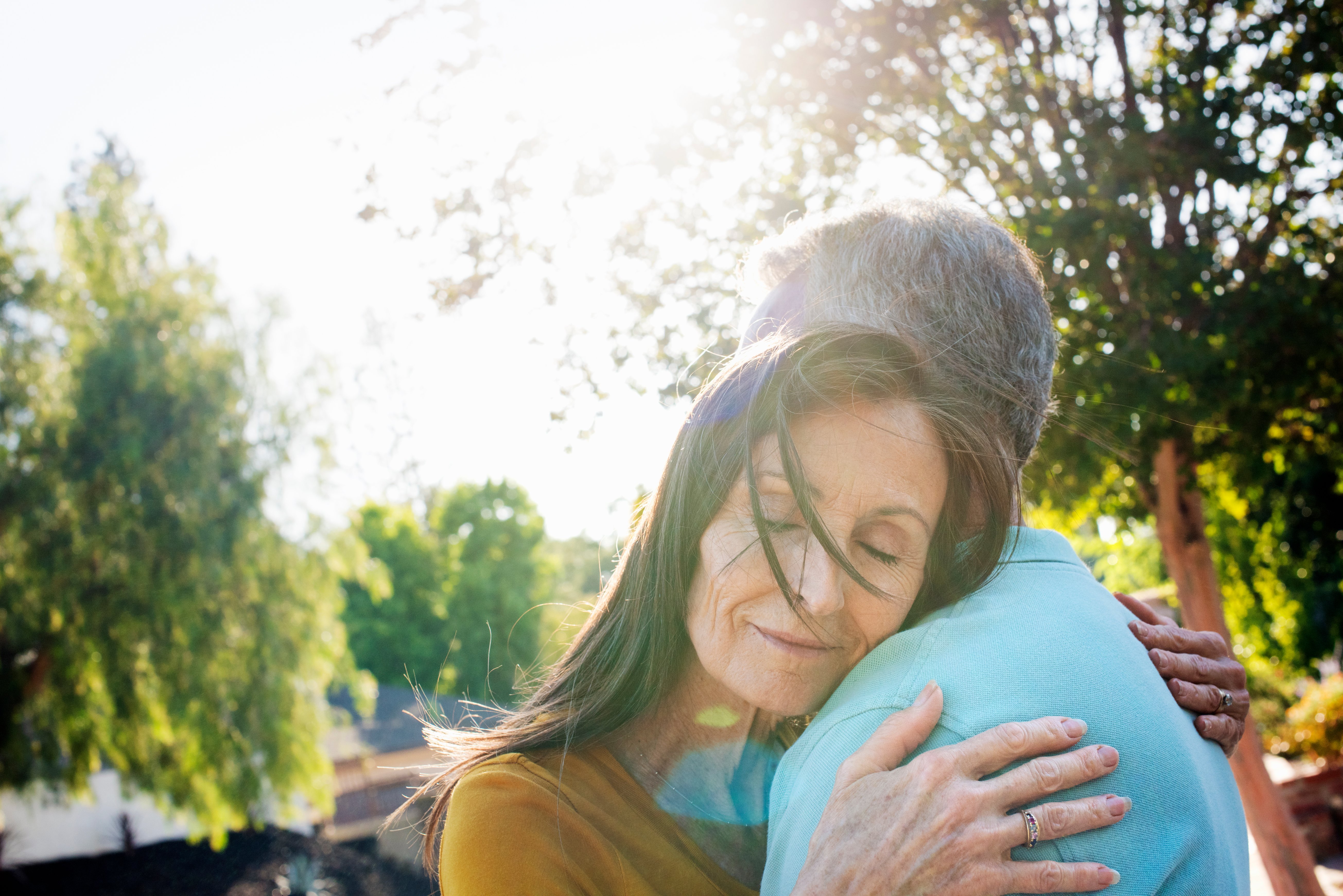 senior-couple-hugging-in-sunny-spot