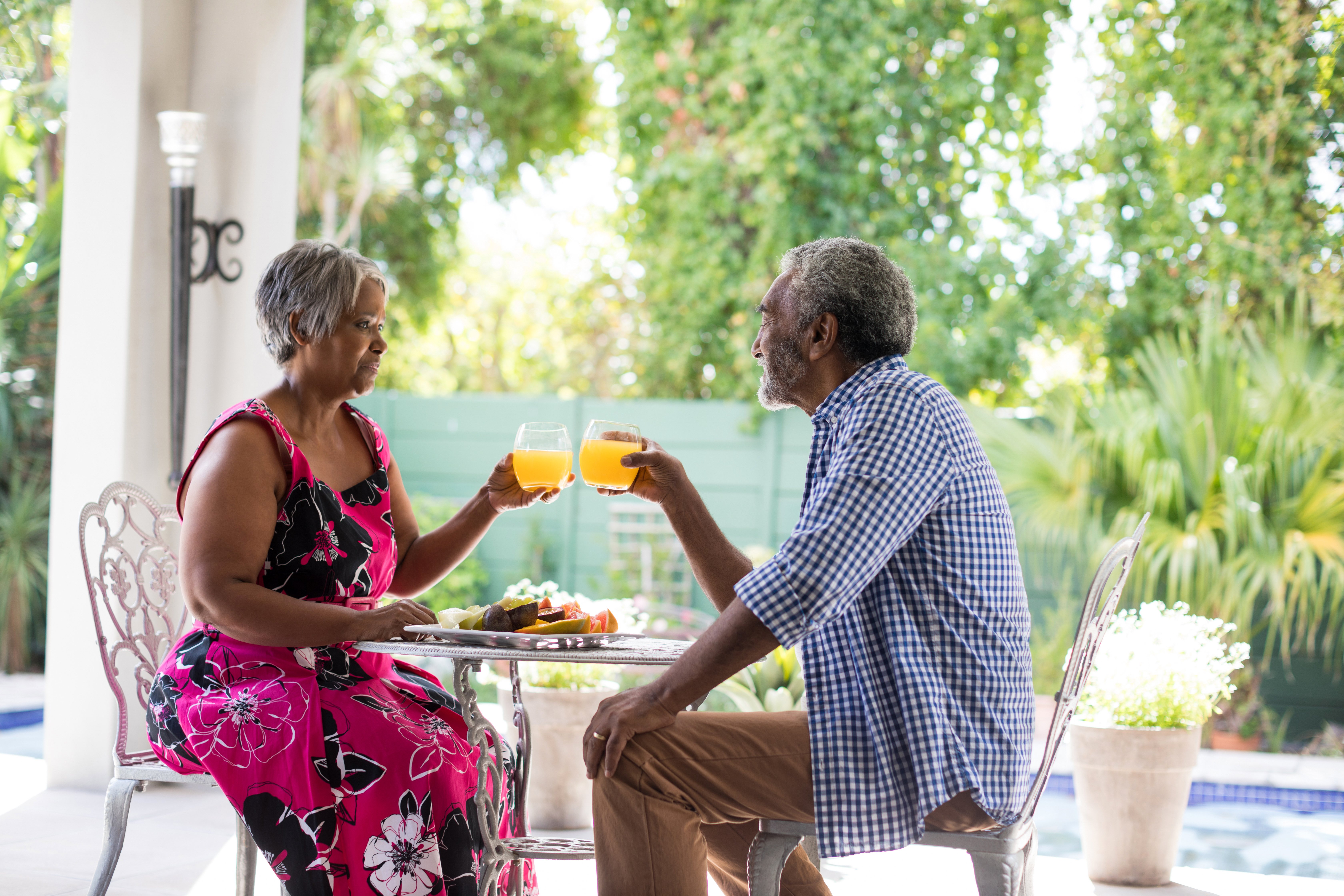 senior-couple-toasting-drinking-glasses-LTCQEK4