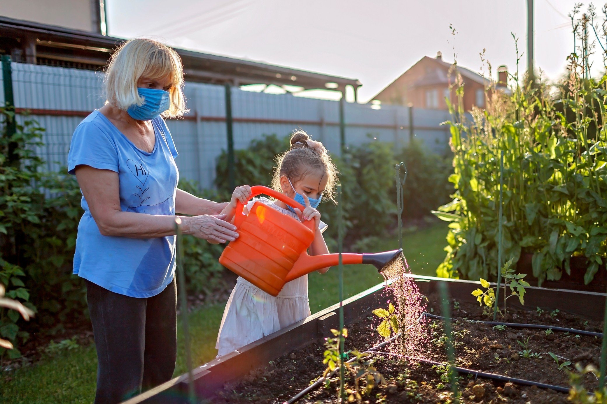 A girl waters plants with her grandma, an example of the freedoms you have with home care