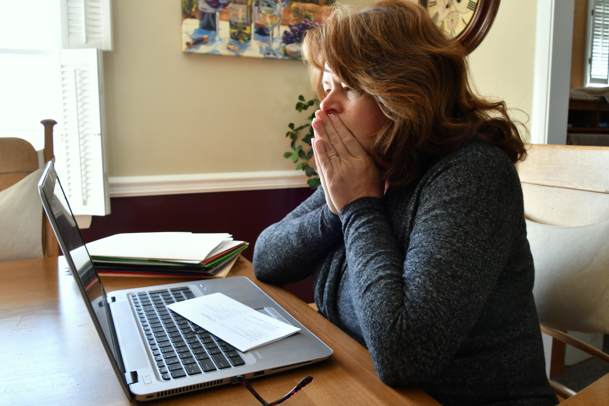 woman-sitting-at-laptop-looking-overwhelmed