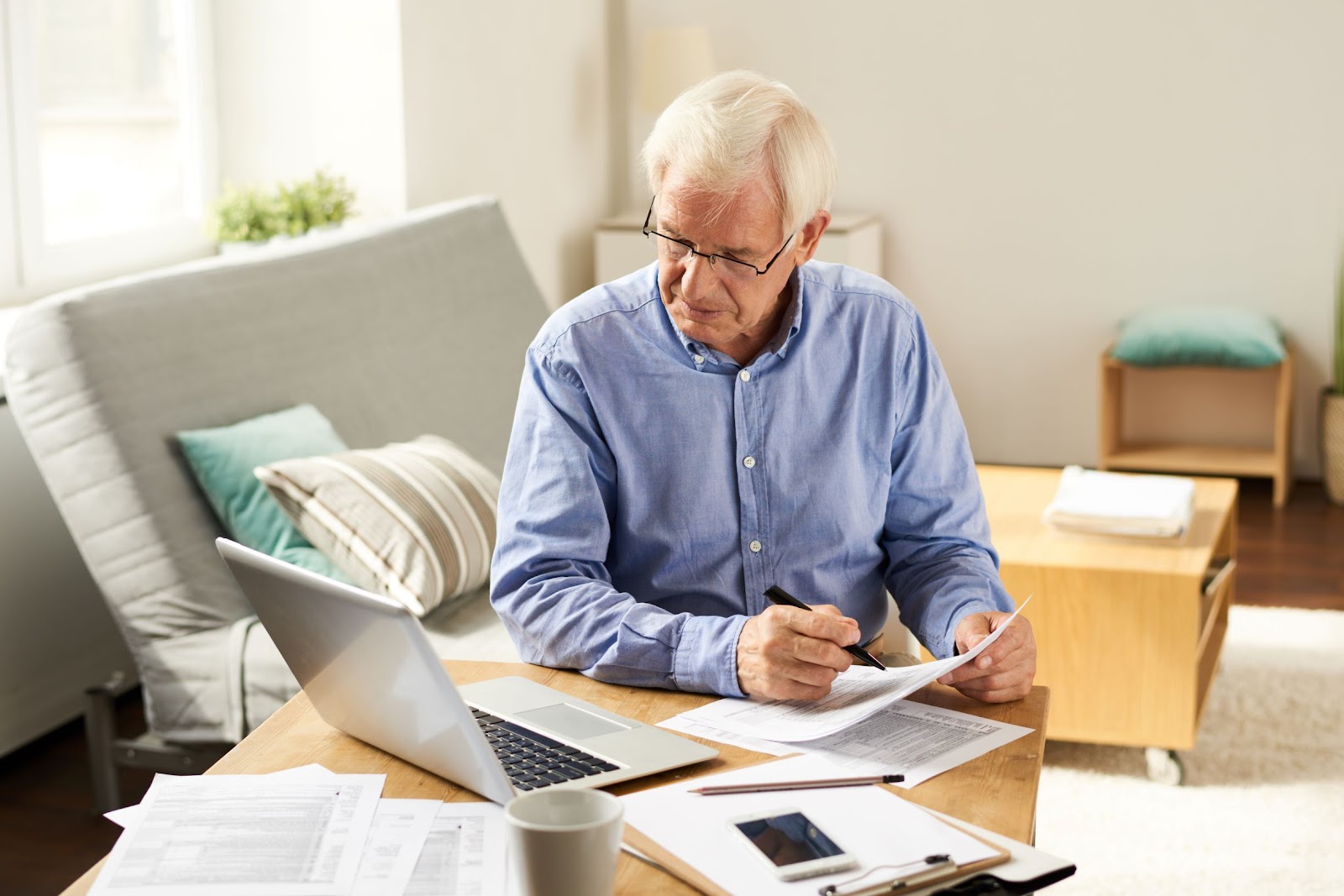 senior-man-filing-taxes-in-living-room