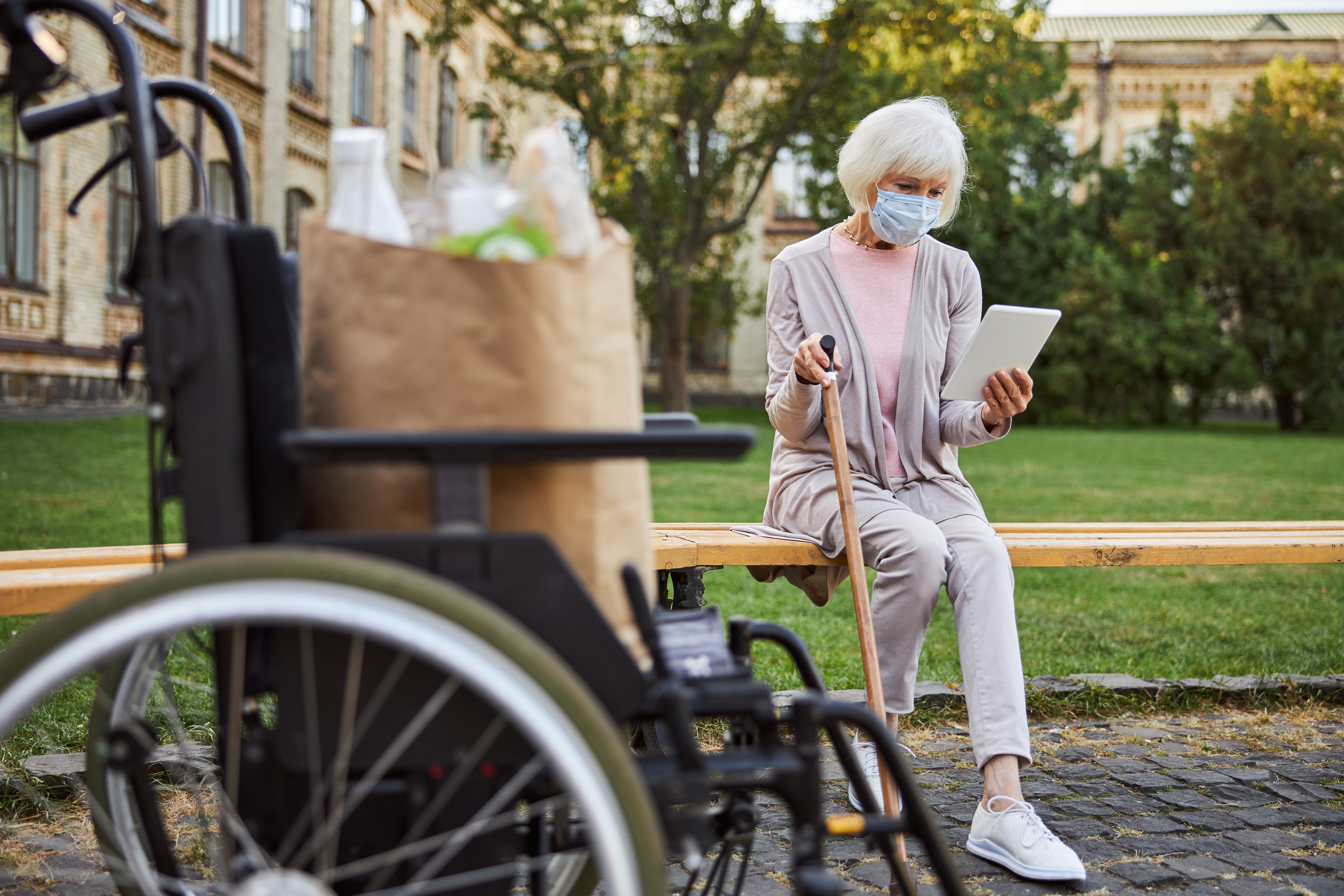 woman-with-disability-using-ipad-in-the-park